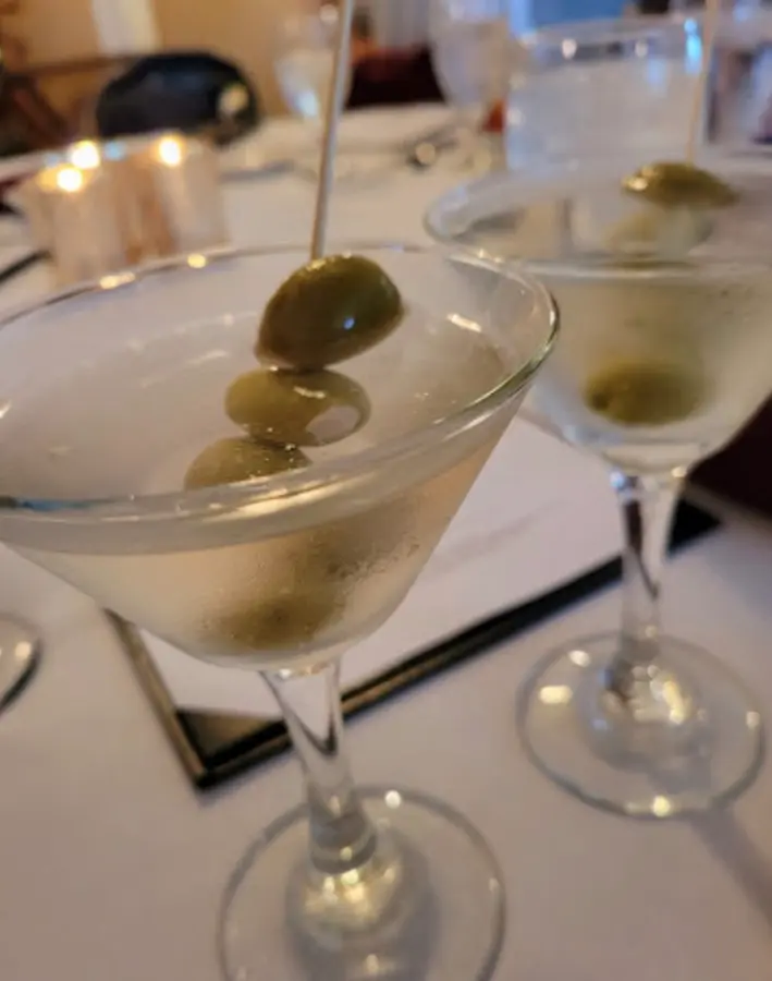 Martinis with olives by candlelight